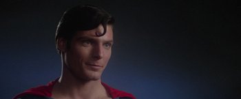 Movie still from “Superman” (1978), directed by Richard Donner – A person wearing a red shirt; Close Up shot, Over the shoulder angle