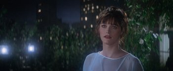 Movie still from “Superman” (1978), directed by Richard Donner – A woman standing in front of a building at night; Close Up shot, Over the shoulder angle