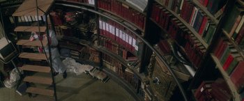 Movie still from “Superman” (1978), directed by Richard Donner – An aerial view of a library with a lot of books; Extreme Wide shot, Overhead angle