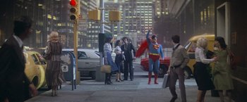 Movie still from “Superman” (1978), directed by Richard Donner – A man dressed as superman is walking down the street; Wide shot, Low angle