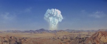 Movie still from “Superman” (1978), directed by Richard Donner – A cloud of smoke rises from the ground in the desert; Extreme Wide shot, Low angle