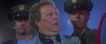 Movie still from “Superman” (1978), directed by Richard Donner – A person wearing a suit and tie; Close Up shot, Low angle