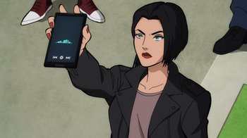 Movie still from “Superman: Man of Tomorrow” (2020), directed by Chris Palmer – A woman is holding up a cell phone; Close Up shot, Over the shoulder angle