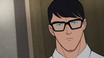 Movie still from “Superman: Man of Tomorrow” (2020), directed by Chris Palmer – A man with glasses is looking at the camera; Close Up shot, Over the shoulder angle