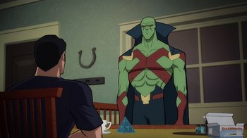 Movie still from “Superman: Man of Tomorrow” (2020), directed by Chris Palmer – A cartoon picture of martian manhunter looking at a table; Medium shot, Over the shoulder angle