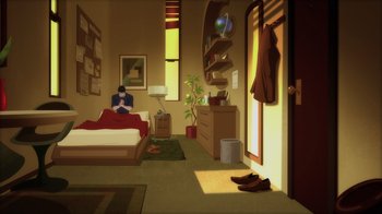 A person sitting on a bed in a room