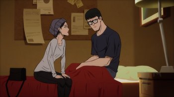 Movie still from “Superman: Man of Tomorrow” (2020), directed by Chris Palmer – A man and a woman sitting on a bed in a room; Medium shot, High angle