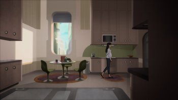 A woman is walking in a kitchen with a table and chairs