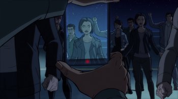Movie still from “Superman: Man of Tomorrow” (2020), directed by Chris Palmer – An image of a person holding a cell phone in front of a group of people; Extreme Close Up shot, High angle