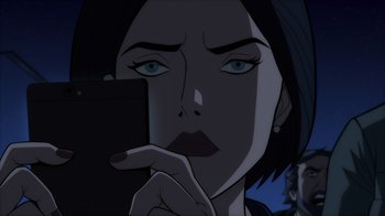 Movie still from “Superman: Man of Tomorrow” (2020), directed by Chris Palmer – A woman with blue eyes is holding her hand up to her face; Close Up shot, Over the shoulder angle