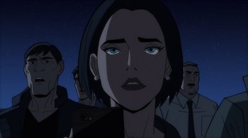 Movie still from “Superman: Man of Tomorrow” (2020), directed by Chris Palmer – A woman is looking at the camera in front of a group of people; Close Up shot, Over the shoulder angle