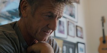 Movie still from “Superpower” (2023), directed by Aaron Kaufman – An older man is sitting in front of a wall; Close Up shot, Low angle