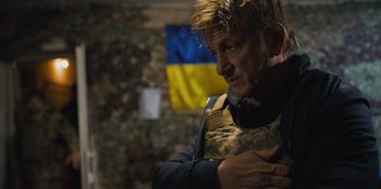 Movie still from “Superpower” (2023), directed by Aaron Kaufman – A person wearing a uniform; Close Up shot, Over the shoulder angle