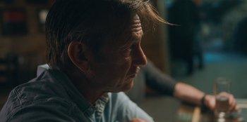 Movie still from “Superpower” (2023), directed by Aaron Kaufman – A person sitting down with his eyes closed; Close Up shot, Over the shoulder angle