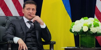 Movie still from “Superpower” (2023), directed by Aaron Kaufman – A man sitting in front of a flag of ukraine; Close Up shot, Low angle