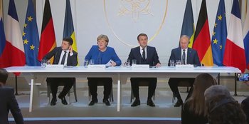 Movie still from “Superpower” (2023), directed by Aaron Kaufman – A group of people sitting around a table; Extreme Wide shot, Low angle