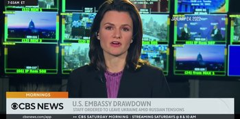 Movie still from “Superpower” (2023), directed by Aaron Kaufman – A woman in a news room talking to the camera; Close Up shot, Low angle