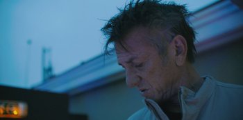 Movie still from “Superpower” (2023), directed by Aaron Kaufman – A person looking down at his face; Close Up shot, Low angle