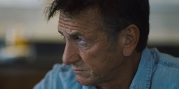 Movie still from “Superpower” (2023), directed by Aaron Kaufman – A man's face with blue eyes; Close Up shot, Low angle