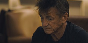 Movie still from “Superpower” (2023), directed by Aaron Kaufman – A person sitting down with his eyes closed; Close Up shot, Low angle