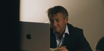 Movie still from “Superpower” (2023), directed by Aaron Kaufman – An older man looking at an apple computer; Close Up shot, Over the shoulder angle