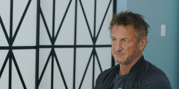 Movie still from “Superpower” (2023), directed by Aaron Kaufman – A person wearing a black jacket; Close Up shot, Over the shoulder angle