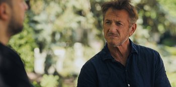 Movie still from “Superpower” (2023), directed by Aaron Kaufman – A person wearing a blue shirt; Close Up shot, Over the shoulder angle