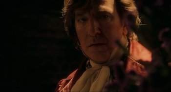 Movie still from “Sweeney Todd: The Demon Barber of Fleet Street” (2007), directed by Tim Burton – A person wearing a suit and tie; Close Up shot, Over the shoulder angle