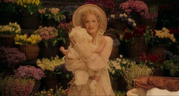 Movie still from “Sweeney Todd: The Demon Barber of Fleet Street” (2007), directed by Tim Burton – A woman holding a teddy bear while wearing a hat; Medium shot, High angle