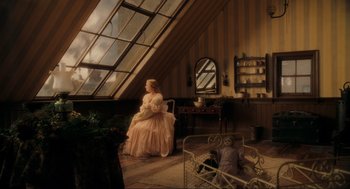 Movie still from “Sweeney Todd: The Demon Barber of Fleet Street” (2007), directed by Tim Burton – A woman in a pink dress sitting in a chair in front of a window; Wide shot, High angle