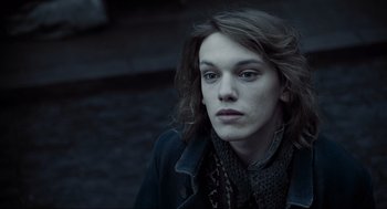 Movie still from “Sweeney Todd: The Demon Barber of Fleet Street” (2007), directed by Tim Burton – A man with long hair and a black jacket; Close Up shot, High angle