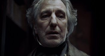 Movie still from “Sweeney Todd: The Demon Barber of Fleet Street” (2007), directed by Tim Burton – An older man with a beard and a mustache; Close Up shot, Over the shoulder angle