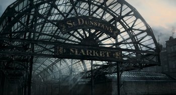 Movie still from “Sweeney Todd: The Demon Barber of Fleet Street” (2007), directed by Tim Burton – A sign for a market in st dunstan's market in london; Extreme Wide shot, Low angle