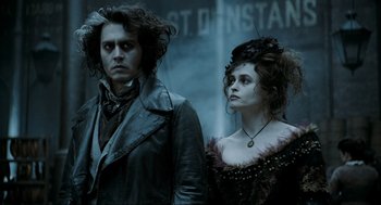 Movie still from “Sweeney Todd: The Demon Barber of Fleet Street” (2007), directed by Tim Burton – Johnny depp and helena bonham - carter in a scene from the movie sweeney todd : the demon barber of fleet street; Medium shot, Low angle