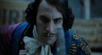 Movie still from “Sweeney Todd: The Demon Barber of Fleet Street” (2007), directed by Tim Burton – A person wearing a suit and tie; Close Up shot, Over the shoulder angle