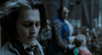 Movie still from “Sweeney Todd: The Demon Barber of Fleet Street” (2007), directed by Tim Burton – A man in a suit and a man in a blue suit and a man in a black suit and a man in a blue suit; Close Up shot, Over the shoulder angle