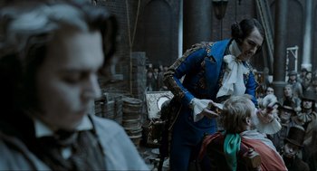 Movie still from “Sweeney Todd: The Demon Barber of Fleet Street” (2007), directed by Tim Burton – A man in a blue suit and a man in a black suit and a boy in a blue suit and a man in a red suit; Medium shot, Over the shoulder angle