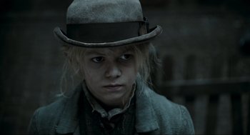 Movie still from “Sweeney Todd: The Demon Barber of Fleet Street” (2007), directed by Tim Burton – A young man wearing a hat and a jacket; Close Up shot, Low angle