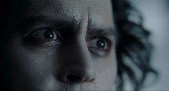Movie still from “Sweeney Todd: The Demon Barber of Fleet Street” (2007), directed by Tim Burton – A man's eyes looking into the camera; Extreme Close Up shot, Low angle