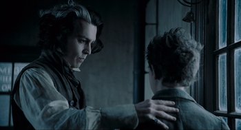Movie still from “Sweeney Todd: The Demon Barber of Fleet Street” (2007), directed by Tim Burton – A man with long white hair is looking at another man with short hair; Close Up shot, Over the shoulder angle