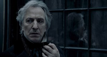 Movie still from “Sweeney Todd: The Demon Barber of Fleet Street” (2007), directed by Tim Burton – An old man with grey hair wearing a black bow tie; Close Up shot, Over the shoulder angle