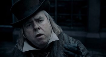 Movie still from “Sweeney Todd: The Demon Barber of Fleet Street” (2007), directed by Tim Burton – A man in a top hat and a leather jacket; Close Up shot, Over the shoulder angle