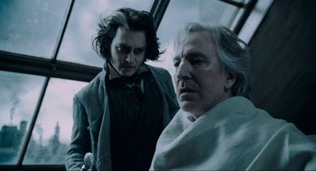 Movie still from “Sweeney Todd: The Demon Barber of Fleet Street” (2007), directed by Tim Burton – Two men are standing next to each other; Close Up shot, Over the shoulder angle