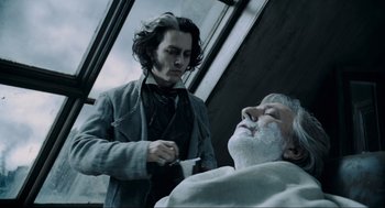 Movie still from “Sweeney Todd: The Demon Barber of Fleet Street” (2007), directed by Tim Burton – Johnny depp shaving a man's face with a razor; Close Up shot, Low angle