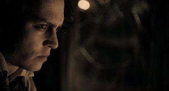 Movie still from “Sweeney Todd: The Demon Barber of Fleet Street” (2007), directed by Tim Burton – A person looking at the camera; Close Up shot, Over the shoulder angle