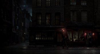 Movie still from “Sweeney Todd: The Demon Barber of Fleet Street” (2007), directed by Tim Burton – A man walking down the street in the dark; Extreme Wide shot, High angle