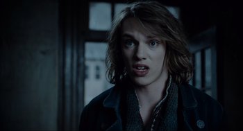 Movie still from “Sweeney Todd: The Demon Barber of Fleet Street” (2007), directed by Tim Burton – A man with long brown hair is looking at the camera; Close Up shot, Over the shoulder angle