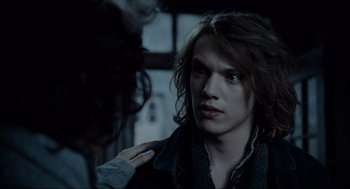 Movie still from “Sweeney Todd: The Demon Barber of Fleet Street” (2007), directed by Tim Burton – A man with long brown hair is looking at the camera; Close Up shot, Over the shoulder angle