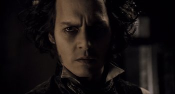 Movie still from “Sweeney Todd: The Demon Barber of Fleet Street” (2007), directed by Tim Burton – A person wearing a black shirt; Close Up shot, Low angle