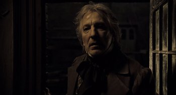Movie still from “Sweeney Todd: The Demon Barber of Fleet Street” (2007), directed by Tim Burton – An older man with long blonde hair wearing a black jacket; Close Up shot, Low angle